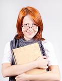 Young smiling fashion girl in glasses with age book.