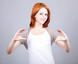 Red-haired businesswoman show something in air.