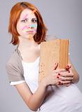 Red-haired businesswoman with book and notes on face. 