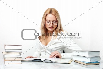 Young pretty woman learning at table with books