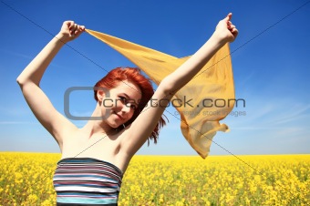 Young woman with open arms keep yellow silk on wind.