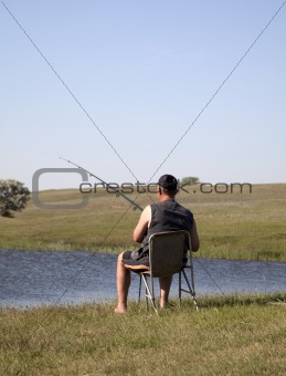 Fishing men at lake.
