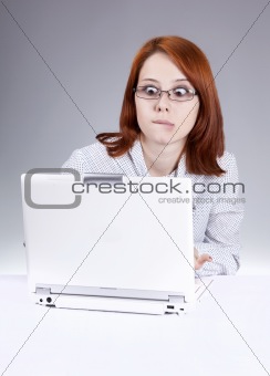 Red-haired girl with white notebook. Studio shot.