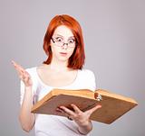 Red-haired businesswoman keep book in hand.