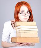 Red-haired businesswoman keep books in hand.