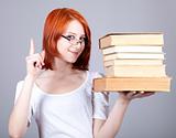 Red-haired smiling businesswoman  keep books in hand.