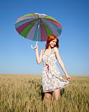 Girl with umbrella at field