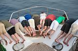 Group of people looking over bow of a boat