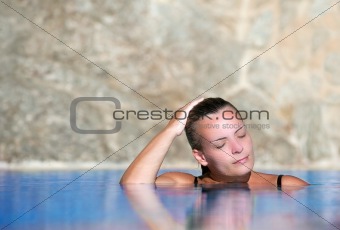 Young woman cools off in pool