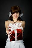 Young attractive woman gives a gift in red box