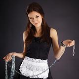 Young beautiful girl in maid costume with a chain