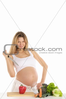 pregnant woman with fruits, vegetables and knife