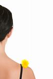 Yellow flower on shoulder at woman kind from back