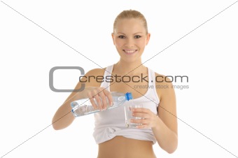 happy woman pours water into a glass
