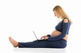 pregnant woman with a laptop sitting on the floor