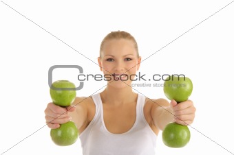 woman engaged in fitness dumbbells from apples