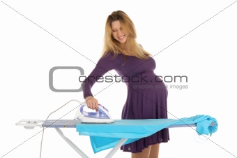 pregnant woman in a purple dress with an iron