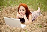 Young  fashion girl with notebook lying at field