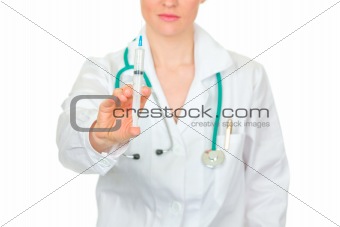 Doctor woman with medical syringe in hands. Close-up.
