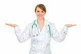 Smiling medical doctor woman presenting something on empty hands
