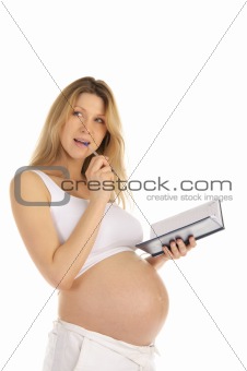 pensive pregnant woman with a notepad