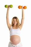 Pregnant woman involved in fitness dumbbells