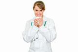 Smiling medical doctor woman holding cup in hands
