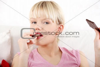 Young woman eating chocolate. 