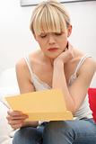 Worried woman's reading letter