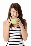 Young woman drinking coffee or tea