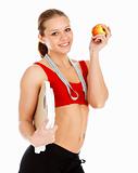 Sports woman holding an apple and carrying a weight scale