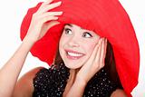 Pretty excited woman in red hat posing against white background.