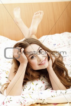 Smiling woman in a bed