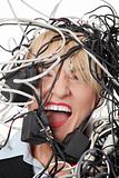 Mature businesswoman's screaming in cables.