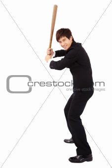 Young and confident  businessman holding  a baseball bat preparing to strike