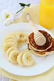 banana cut into slices on a plate with honey, healthy breakfast