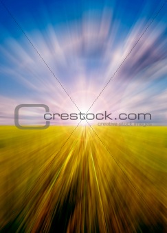 Abstract motion blurred meadow and sky with sun