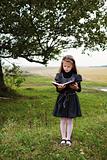 Girl with book outdoors