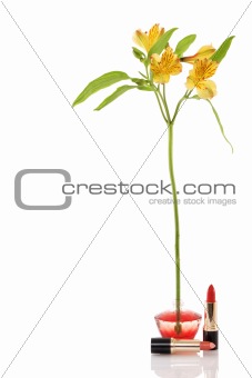 perfume bottle, yellow flower and two red lipstick