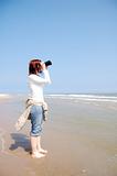Girl with binocular at the beach.