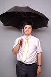 Man under umbrella. Studio shot. 