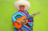 Mexican typical man playing guitar poncho