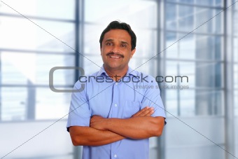 Indian latin businessman blue shirt in modern office