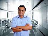 indian latin businessman glasses blue shirt in office