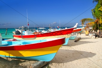 colorful tropical boats beached in sand Isla Mujeres
