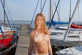 Attractive young woman near the yachts