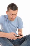 casual young man sending sms on the mobile phone. isolated