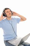 young handsome man listening to music in headphones