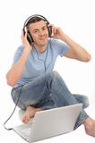 young handsome man listening to music in headphones