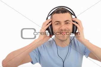 young handsome man listening to music in headphones. isolated